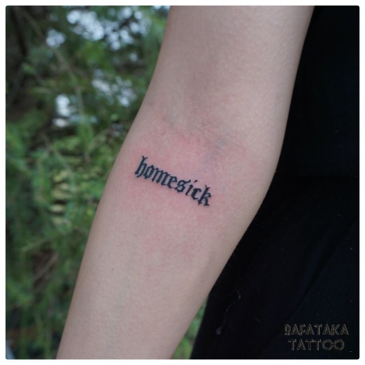 a person with a tattoo on their arm that says bomberick in black ink