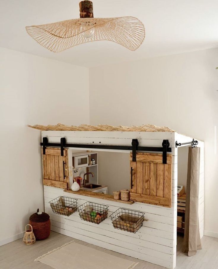 a kitchen area with wooden cabinets and baskets on the counter, hanging from a ceiling fan