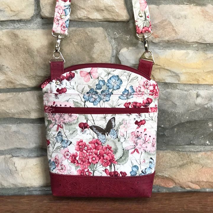 a floral purse hanging on a brick wall