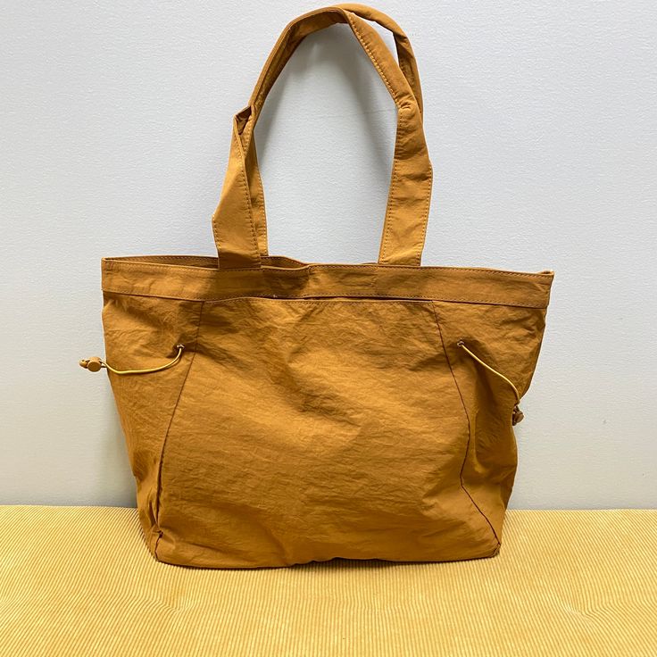 Introducing, the nylon cinch tote! This high quality bag will be your new favorite! They feature 1 main compartment for storing items! Make it a purse, tote, beach bag, and so much more. One main compartment One size slip pocket Snap closure Handles feature a 7.5” drop, for arm or shoulder carry Size is approximately 16”x14”x5” Thick & soft nylon material outer Tote Beach Bag, Kimono Sweater, Pride Gifts, Accessory Pouch, Denim Leggings, Jeans For Sale, Long Sleeve Cardigan, Beach Bag, Snap Closure