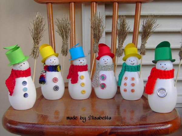 a group of snowmen standing next to each other on top of a wooden table