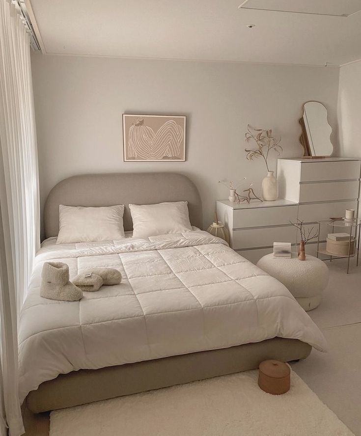 a bedroom with a bed, dressers and mirror in it's center area