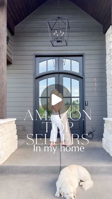 a white dog laying on top of a porch next to a door