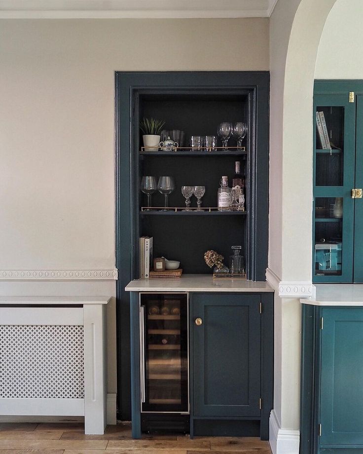 a kitchen with blue cabinets and white walls