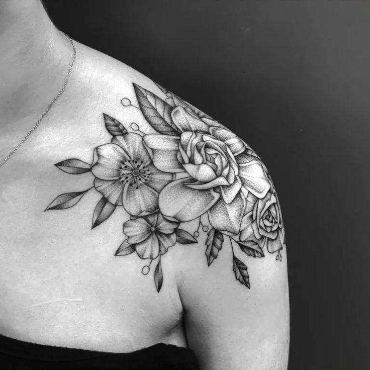 a woman with a flower tattoo on her shoulder