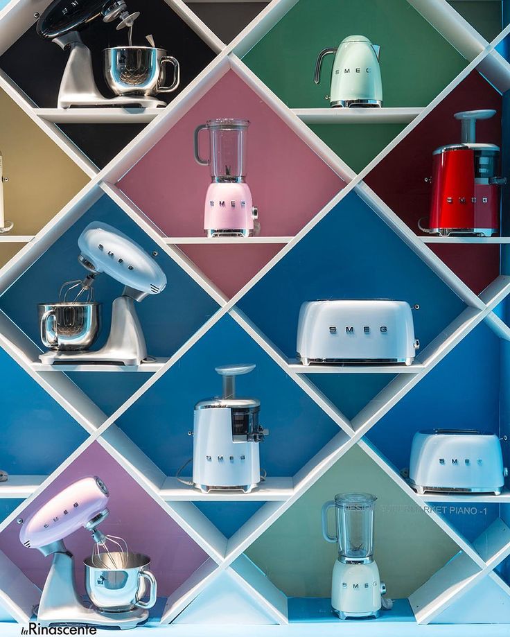 colorful kitchen appliances are displayed on shelves