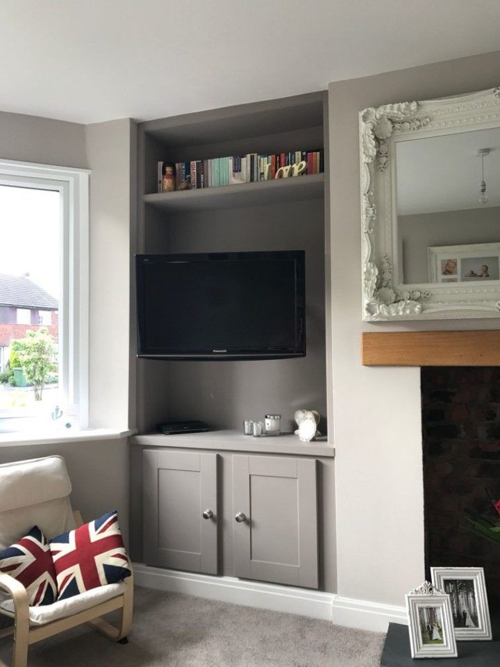 a living room with a fireplace and entertainment center