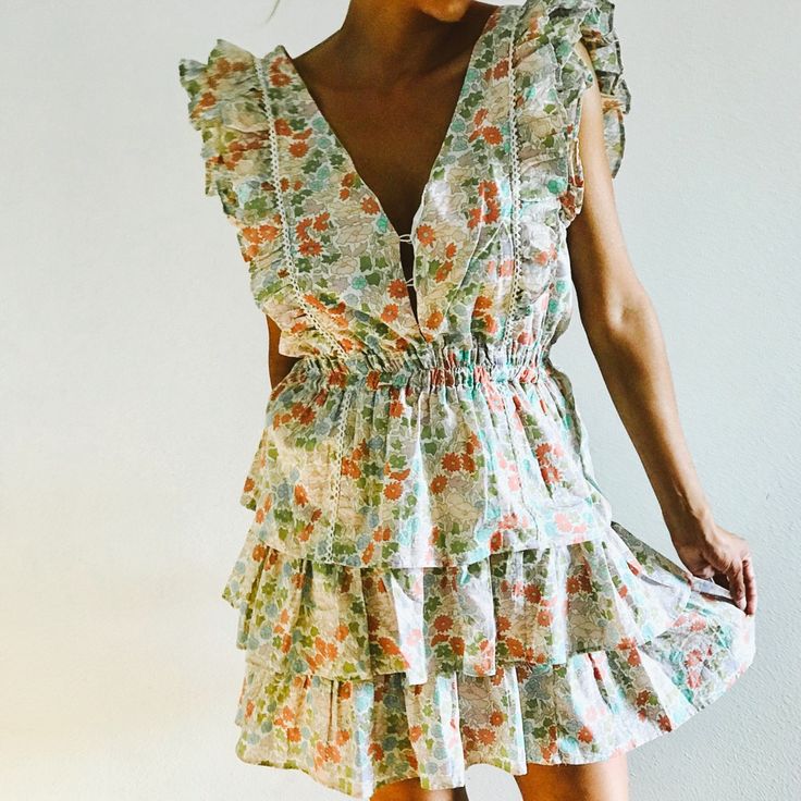 Anthropologie’s Ines Floral Ruffle Dress By Love The Label Head Turner Dress Flower Print In Greens And Pink 3 Buttons In The Front Cute Ruffle Sleeves And Skirt This Dress Will Fit A Small And/Or Medium Brand New With Tags Size Small Summer Floral V-neck Dress With Ruffles, Feminine V-neck Ruffle Dress For Garden Party, Summer V-neck Dress With Ruffled Skirt, Flirty V-neck Dresses For Daywear, Flirty V-neck Daywear Dresses, Flowy Ditsy Floral Print Dress With Ruffle Sleeves, Flowy Dress With Ditsy Floral Print And Ruffle Sleeves, Chic Dresses With Ditsy Floral Print And Flutter Sleeves, Spring Floral Dress With Ruffle Sleeves For Brunch