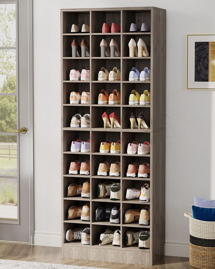 a large shoe rack with many pairs of shoes on it in the corner of a room