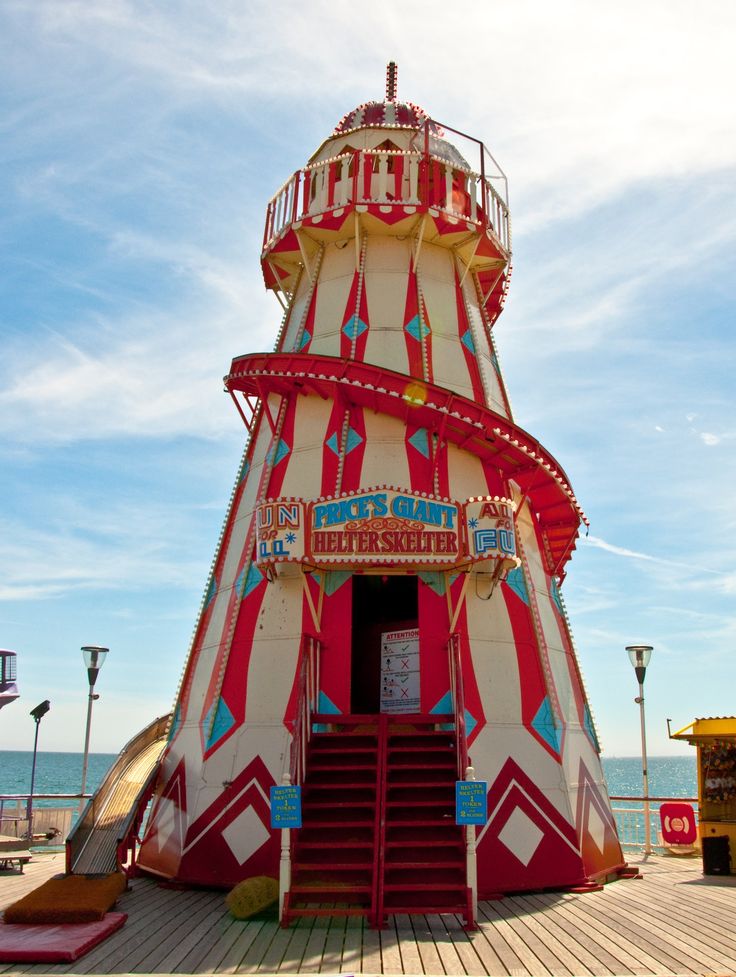 a large red and white tower sitting on top of a pier