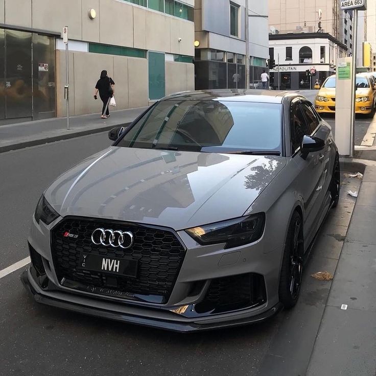 a silver car parked on the side of a street