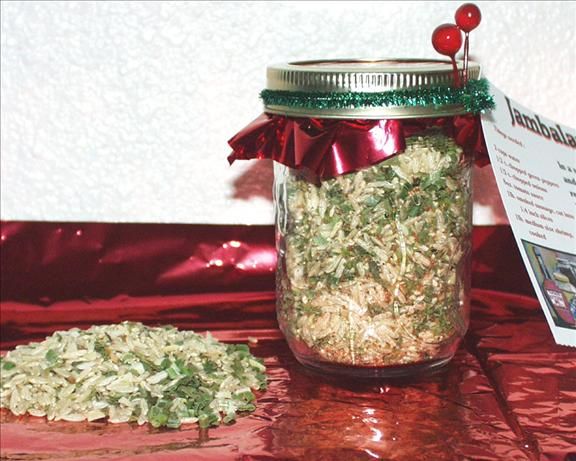 a jar filled with food sitting on top of a red table cloth next to a book