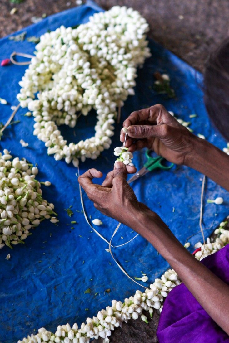 a woman is working on some flowers