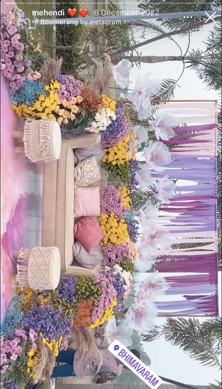 an arrangement of flowers and sweaters is displayed in front of a wallpapered background