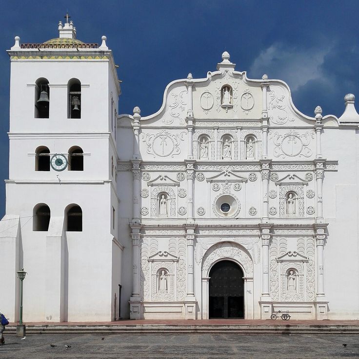 an old white church with two bell towers