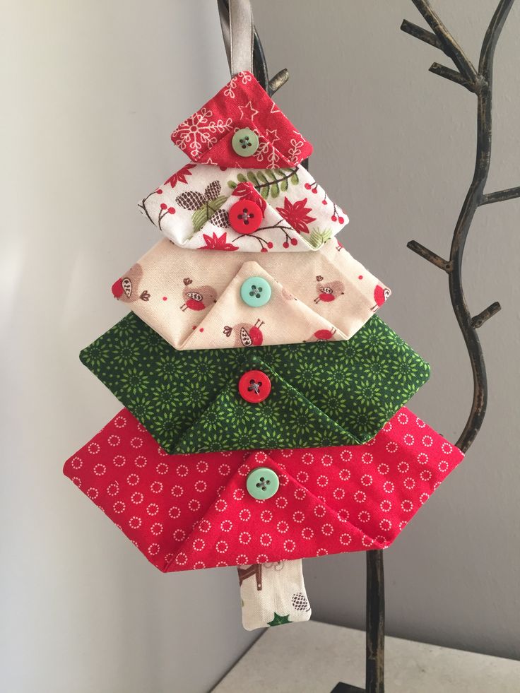 a christmas tree made out of fabric and buttons