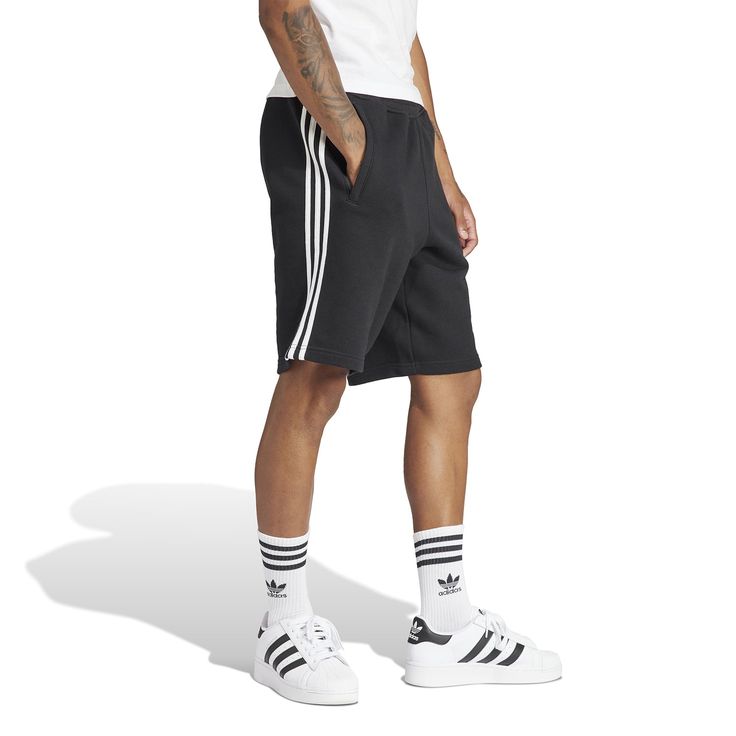 Three stripes for the win! In the adidas 3-Stripe Men's Shorts, you'll be repping your brand with these shorts that are so obviously adidas with their three-stripes. The elastic waistband means they'll stay up well but doesn't require you to be uncomfortable with a button or tight fit. These are ideal for on and off the court and are easy to match with a tee or even a hoodie (if you're into that look in the winter).Features: Features three stripes down side. Has adidas logo on the leg. Elastic w Nba Clothing, Outfit Verano, Sports Field, Adidas Originals Sneakers, White Kicks, Accessories Bags Shoes, Just Style, Plus Size Hoodies, Adidas Shorts