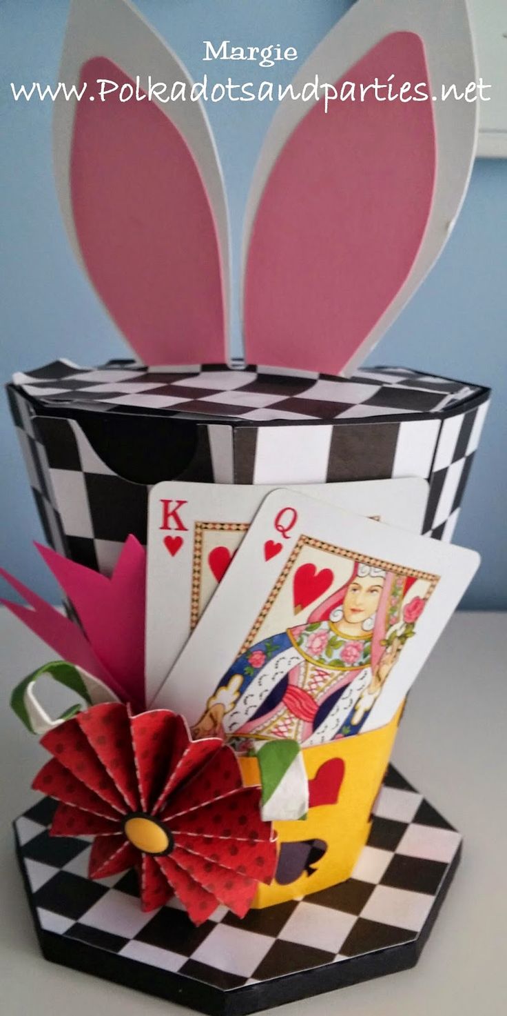 an origami card holder with cards in it and bunny ears sticking out of the top