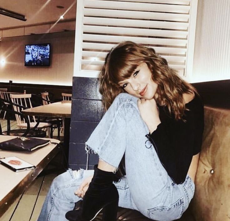 a woman sitting on top of a couch in a restaurant