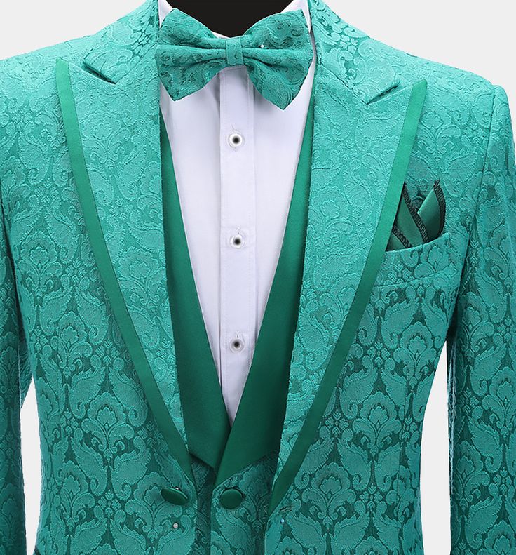 This men's three-piece green damask tuxedo is sure to get you noticed at your next formal affair. This fancy outfit is finely handcrafted from a high-quality material with a delicately textured damask design. This elegant tuxedo set comes with a patterned blazer, a matching vest, and dress pants. The contrasting peak collar, buttons, and pocket piping all provide added class and interest to this set. The lightweight fabric is soft and comfortable as well as stain-resistant. The vest/waistcoat ha Patterned Blazer, Green Tuxedo, Fancy Outfit, Damask Design, Vest Waistcoat, Tuxedo Jacket, Fancy Outfits, Three Piece, Teal Green