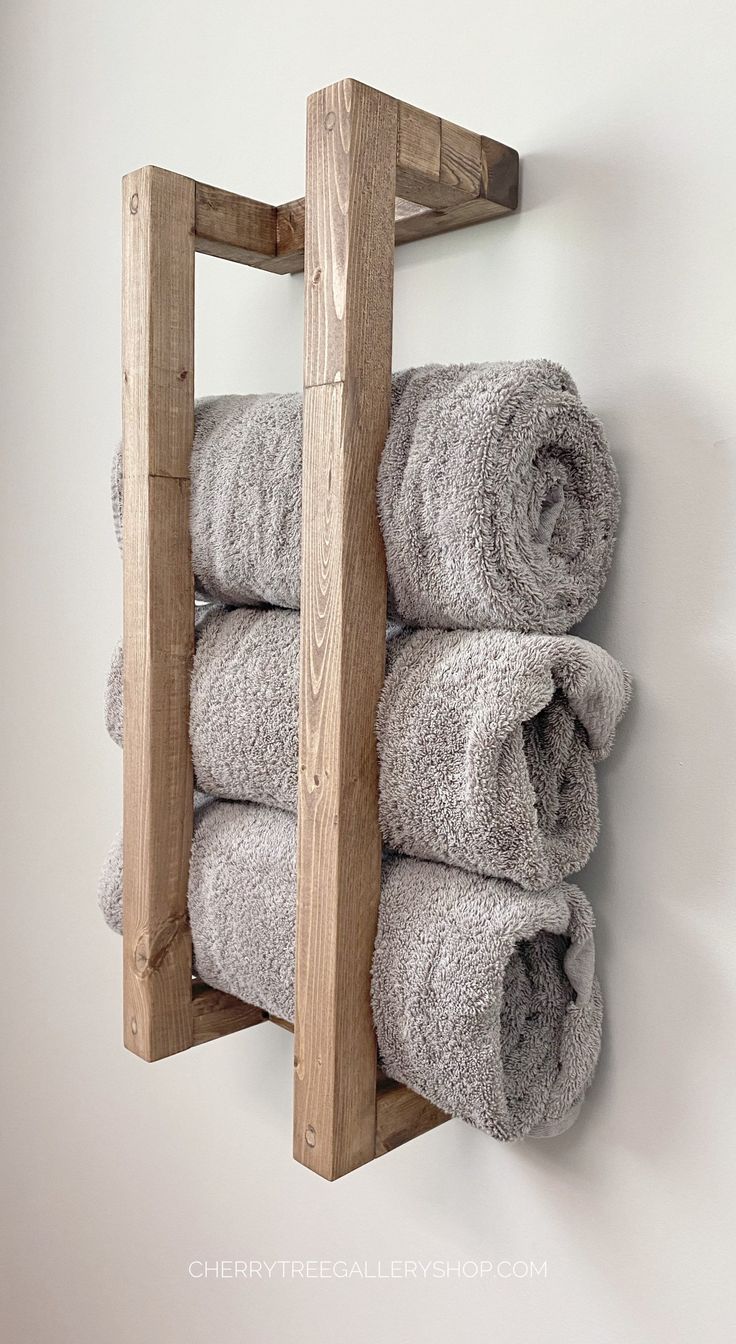 there is a wooden rack with towels on it