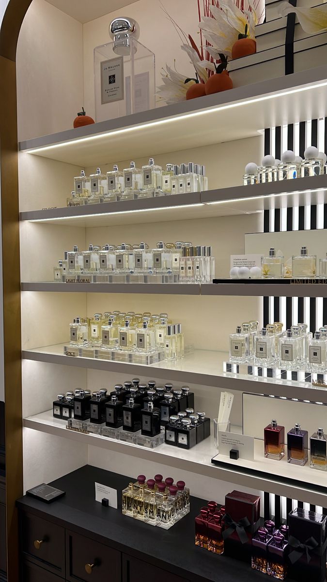 the shelves are filled with different types of perfumes