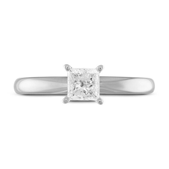 a princess cut diamond ring on a white background