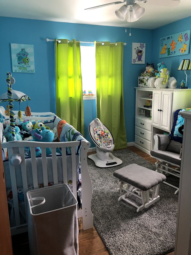 a baby's room with blue walls and green curtains