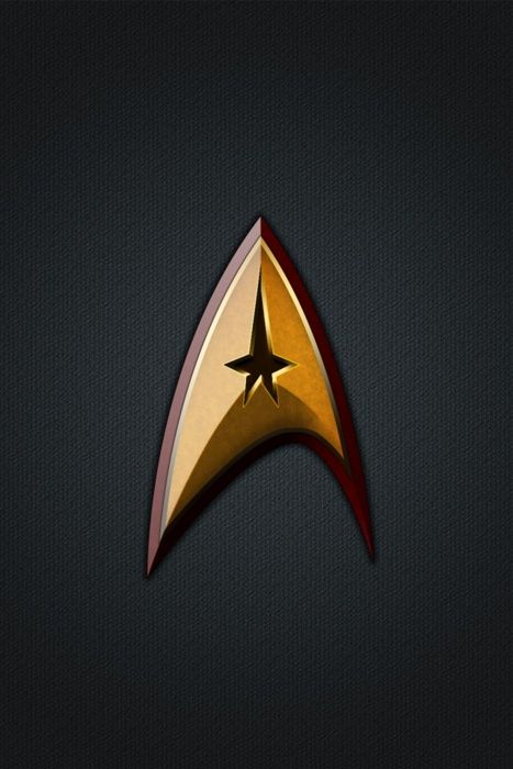 the star trek insignia is shown on a dark background with red trims and gold accents