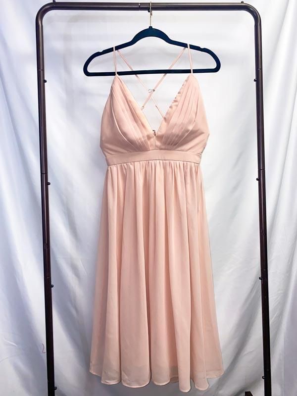 Light Pink Chiffon Dress We dedicate this dress to the soft romance of life. A single touch, a caress, a forehead kiss. The little moments that pass so quickly yet feel eternal. Twirl under the stars in this sweet romantic dress. This beautiful dress is made of light pink chiffon with pleating at the breast. Adjustable spaghetti straps cross at back. Closes with a zipper at the back of the waistband. The underlayer is stretchy full-coverage fabric. Dress length varies from knee-length to calf-le Pink Elegant Chiffon Dress For Casual Events, Elegant Pink Chiffon Dress Down Dress, Elegant Pink Chiffon Dress For Casual Occasions, Elegant Pink Chiffon Dress Down, Feminine Cream Chiffon Dress, Elegant Apricot Chiffon Dress, Pink Chiffon Dress For Wedding Guest, Pink Chiffon Maxi Dress With Spaghetti Straps, Feminine Flowy Dress For Wedding Guest