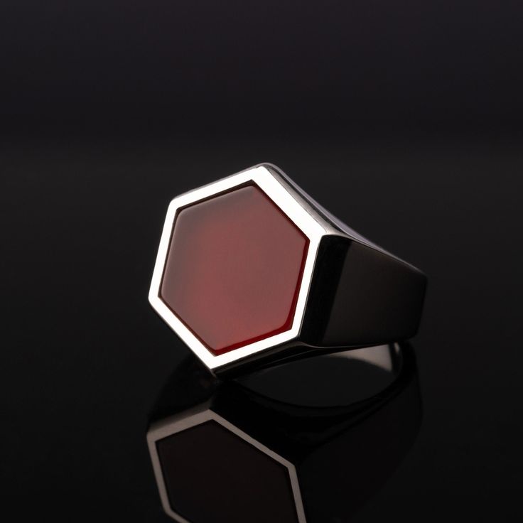 This stunning ring is handcrafted with the highest attention to detail and sparkles with radiant beauty. The Hexagon Cut gemstones - Turquoise, Tiger's Eye, Onyx, and Red Garnet - are perfectly set in a sterling silver band with intricate detailing, creating an opulent and elegant piece of jewelry that you will treasure for years to come. The bold design of this ring will make it the standout of any outfit, complementing your look and expressing your own unique style. The vibrant contrast between the four beautiful gemstones creates a striking statement of sophistication and flair. Featuring a deep blue turquoise, an exotic tiger's eye, a subtle onyx, and an alluring red garnet, this ring will have people admiring your incredible fashion sense. Made with 925 sterling silver, this exquisite Fine Jewelry Octagon Ring With Polished Finish, Modern Red Ring Jewelry, Modernist Gemstone Jewelry For Gifts, Octagon Signet Ring With Polished Finish As Gift, Modernist Gemstone Signet Ring As Gift, Modern Octagon Signet Ring As Gift, Red Octagon-shaped Jewelry For Formal Occasions, Modern Octagon Signet Ring For Gift, Red Octagon Jewelry For Formal Occasions