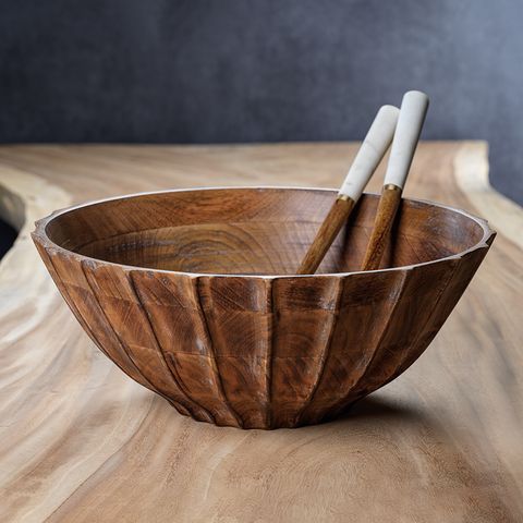 a wooden bowl with two chopsticks in it