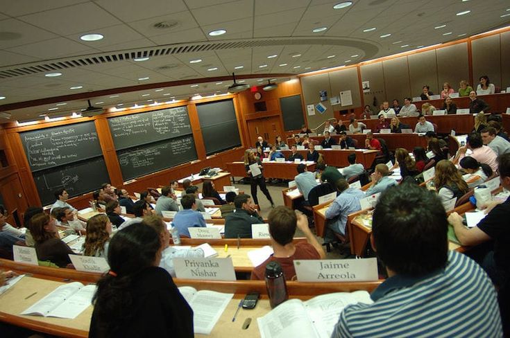 a class room full of people sitting at desks