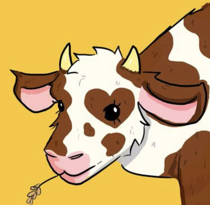 a brown and white cow standing on top of a yellow field