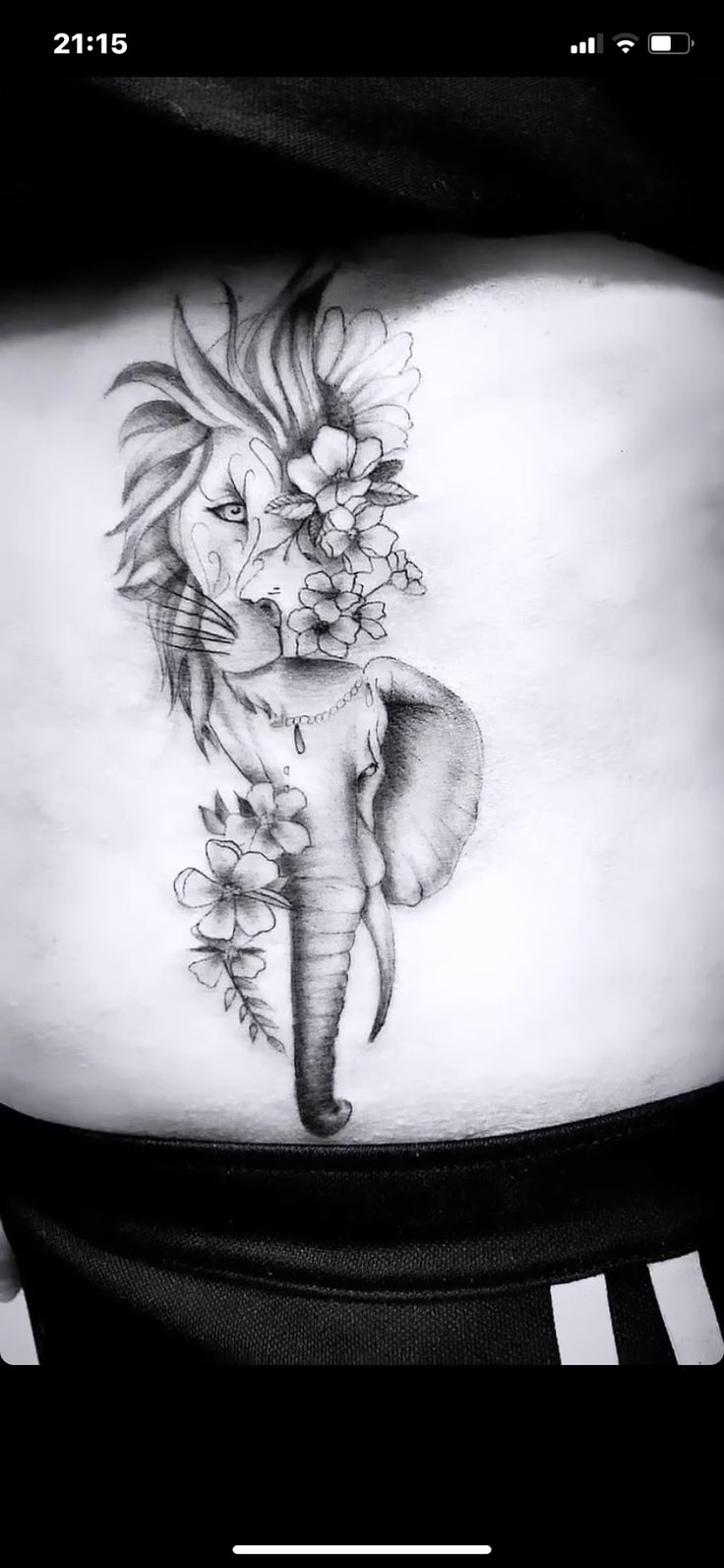 an elephant and flowers tattoo on the stomach