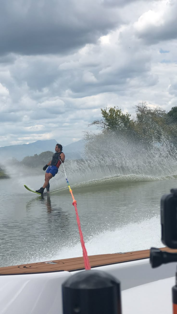 a man riding skis on top of a body of water