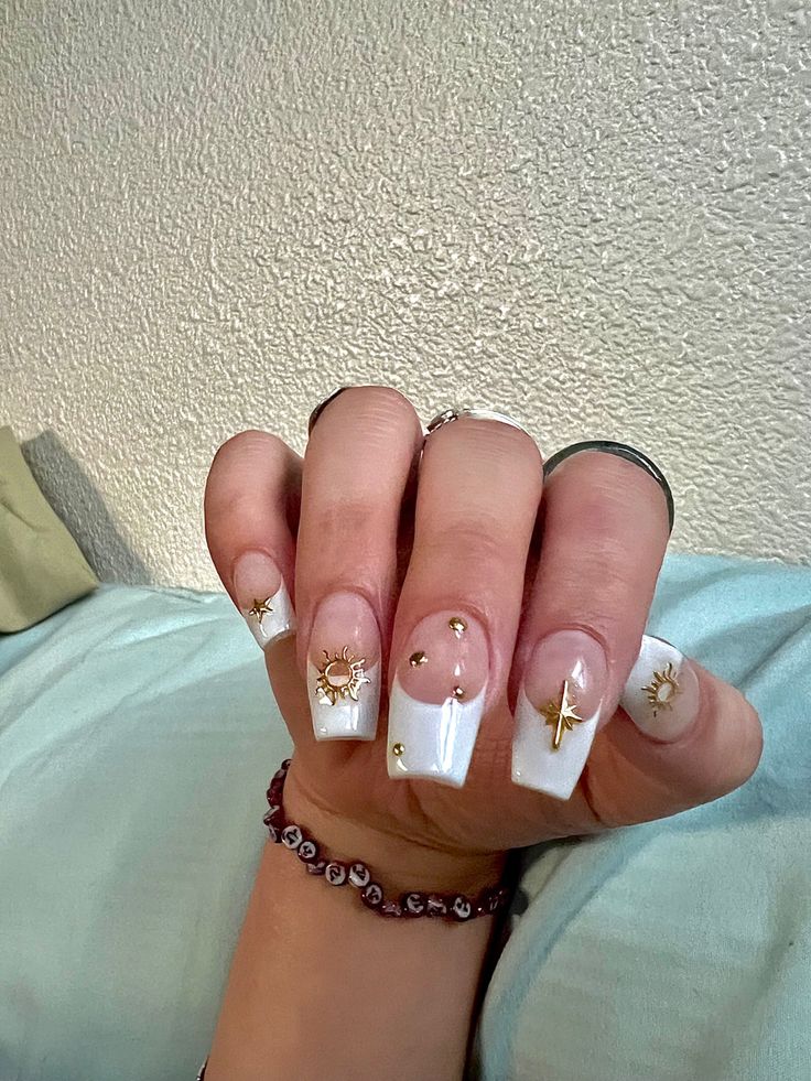 White Nails With Gold Cross, White French Tip Nails With Gold Charms, French White Nails Design, Nail Designs With Gold Charms, White French Tip With Gold Charms, White French With Charms, White French Tip With Gold Design, White Nails With Gold Charms, French Tip With Gold Charms