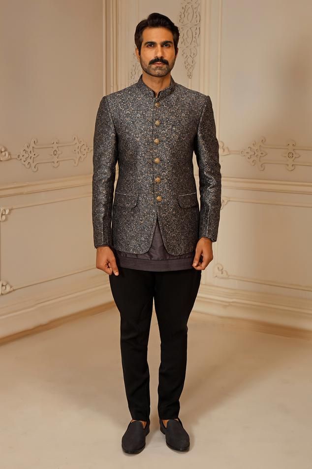 Grey full sleeves jodhpuri bandhgala in silk base with all over floral gardenia pattern and front shank buttons detail. Paired with dupion silk kurta.
Components: 2
Pattern: Gardenia
Neckline: Band Collar
Sleeve Type: Long
Fabric: Silk
Color: Grey
Other Details: 
Note: The trouser worn by the model is not for sale
Occasion: Wedding - Aza Fashions Semi-formal Bandhgala With Dabka, Semi-formal Long Sleeve Bandhgala With Dabka, Nehru Jacket With Naqshi For Semi-formal Eid Occasions, Unstitched Nehru Jacket For Semi-formal Festivals, Designer Bandhgala For Semi-formal Occasions, Traditional Nehru Jacket For Semi-formal Transitional Season, Traditional Long Sleeve Bandhgala For Semi-formal Occasions, Semi-formal Nehru Jacket For Festivals With Long Sleeves, Semi-formal Long Sleeve Nehru Jacket For Festivals