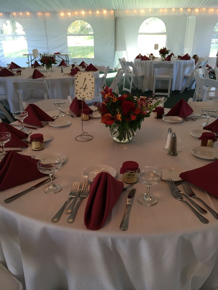 the table is set with silverware and red napkins