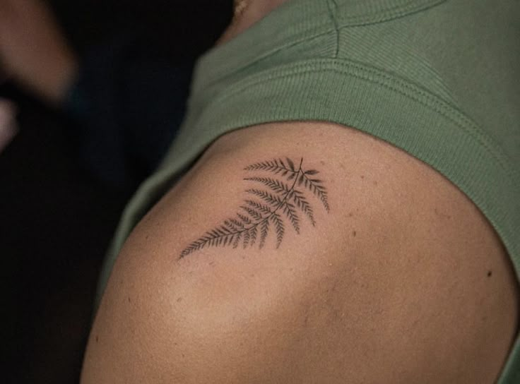 a woman with a fern tattoo on her shoulder