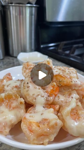 a white plate topped with donuts covered in icing next to a stove top