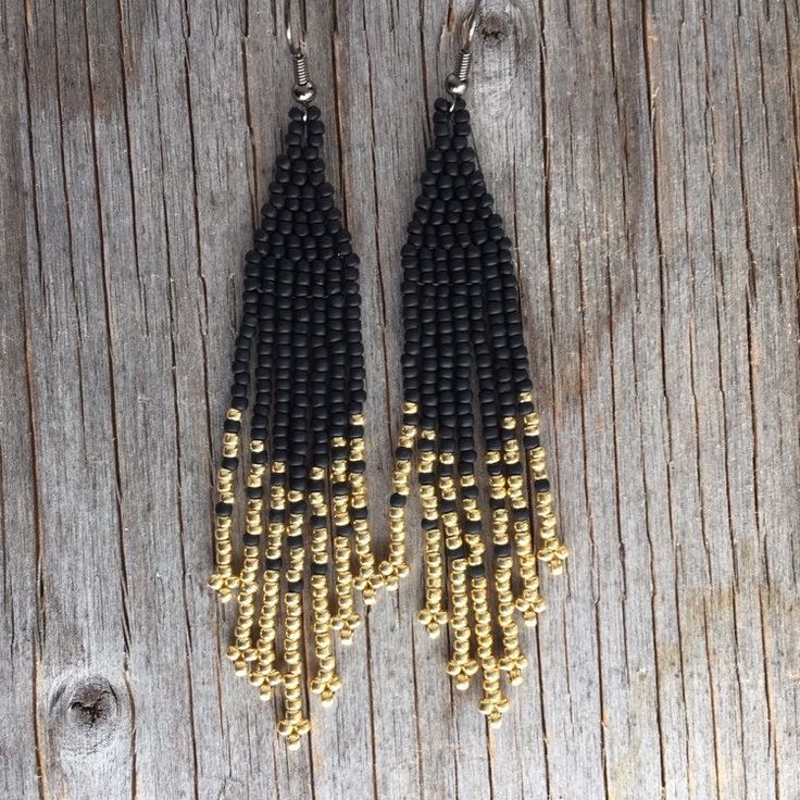 Native American earrings. Arrow pattern including seed beads in matte and metallic with warm colors black and gold. These earrings measure 3 1/2 inches with your choice of ear wires. If you want a custom order :  contact me . Each of my creations is inspired by nature . Thank you and happy ! Black Beaded Earrings With Round Beads And Fringe, Black Beaded Fringe Earrings With Round Beads, Gold Beaded Fringe Earrings With Adjustable Fit, Gold Beaded Earrings With Fringe, Adjustable Gold Beaded Earrings With Black Beads, Gold Dangle Earrings With Black Beads, Black Beaded Tassel Earrings With Round Beads, Black Bohemian Beaded Earrings With Gold Beads, Adjustable Black Beaded Tassel Earrings