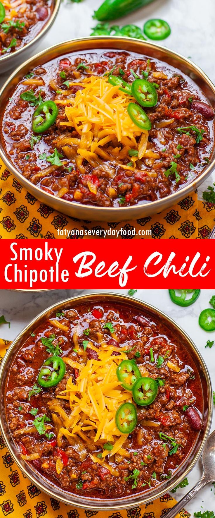 two bowls of chili with cheese and green peppers