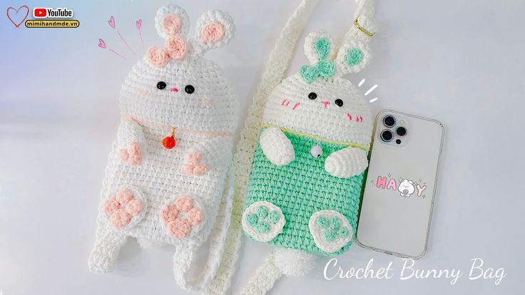 two crocheted bunny bags next to an iphone