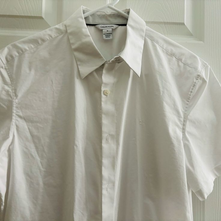 Medium Size Calvin Klein White. Nwot. In A Very Excellent Condition. No Stains Nor Marks . Smoke Free Environment. Calvin Klein Everyday Summer Tops, Calvin Klein Tops For Everyday Summer Wear, Classic Calvin Klein Tops For Everyday, Calvin Klein Spring Tops For Everyday Wear, Calvin Klein White Short Sleeve Shirt, White Calvin Klein Casual Shirt, Calvin Klein Casual Short Sleeve Shirt, Calvin Klein Casual Relaxed Fit Shirt, White Short Sleeve Calvin Klein Shirt