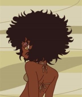 a woman with an afro standing in front of a wall