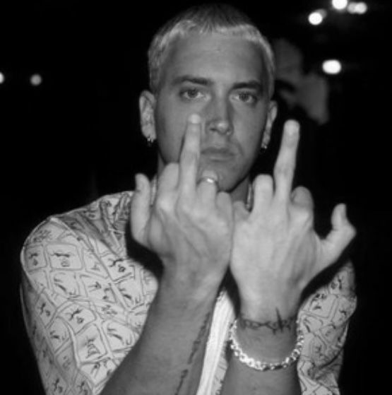 a black and white photo of a man with his hands in the air