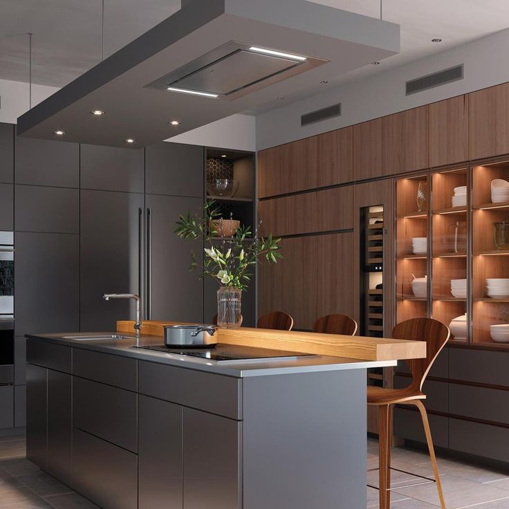 a modern kitchen with an island and stainless steel appliances in front of a large window