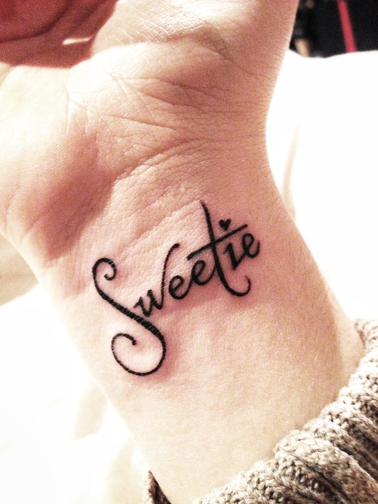 a woman's wrist tattoo with the word sweetie written in cursive font