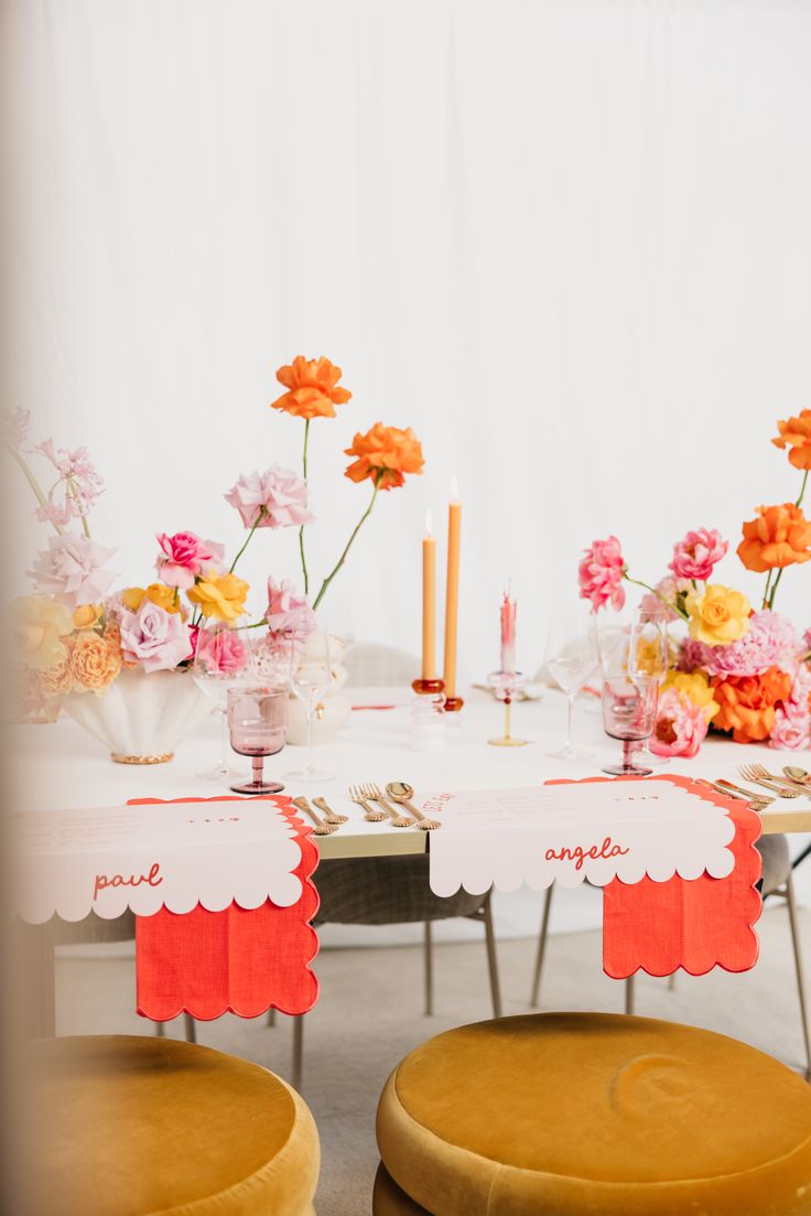 the table is set with flowers and place settings